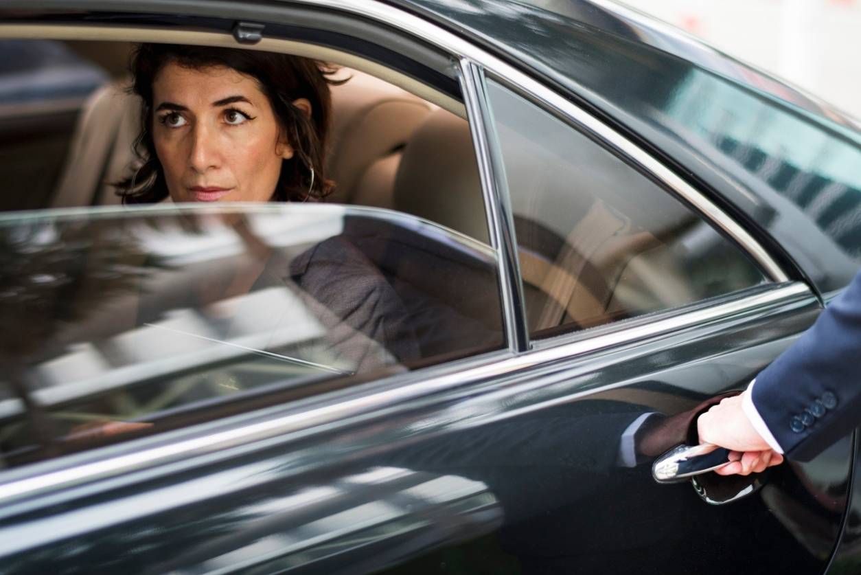 A Business Woman Sitting in Limousine Aurora