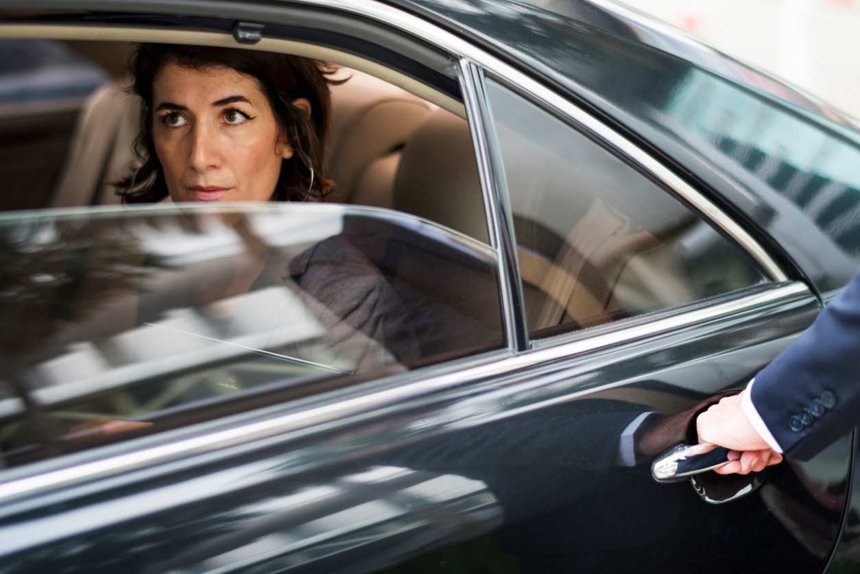 A Business Woman Sitting in a Luxury Limousine
